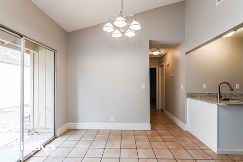 A kitchen area with a sink and a window.