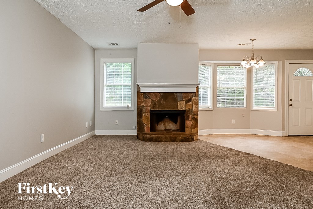 the living room of a house with a stone fireplace