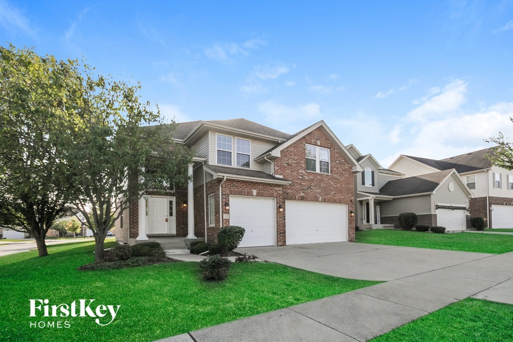 A house with a tree in front of it and the words "FirstKey Homes" on the bottom left.