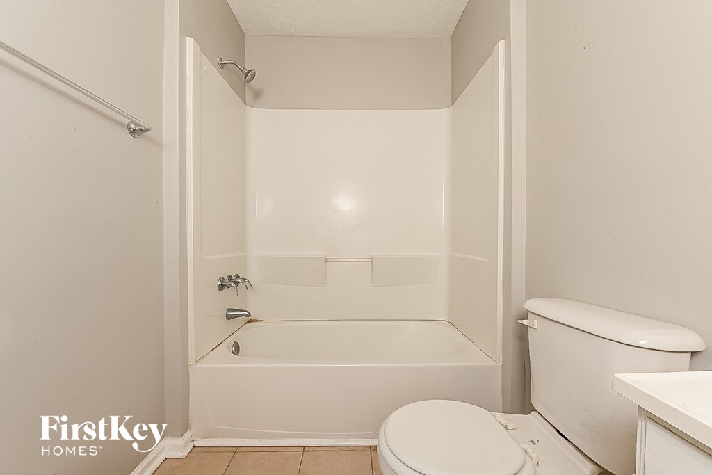 a bathroom with a tub and a toilet and a sink