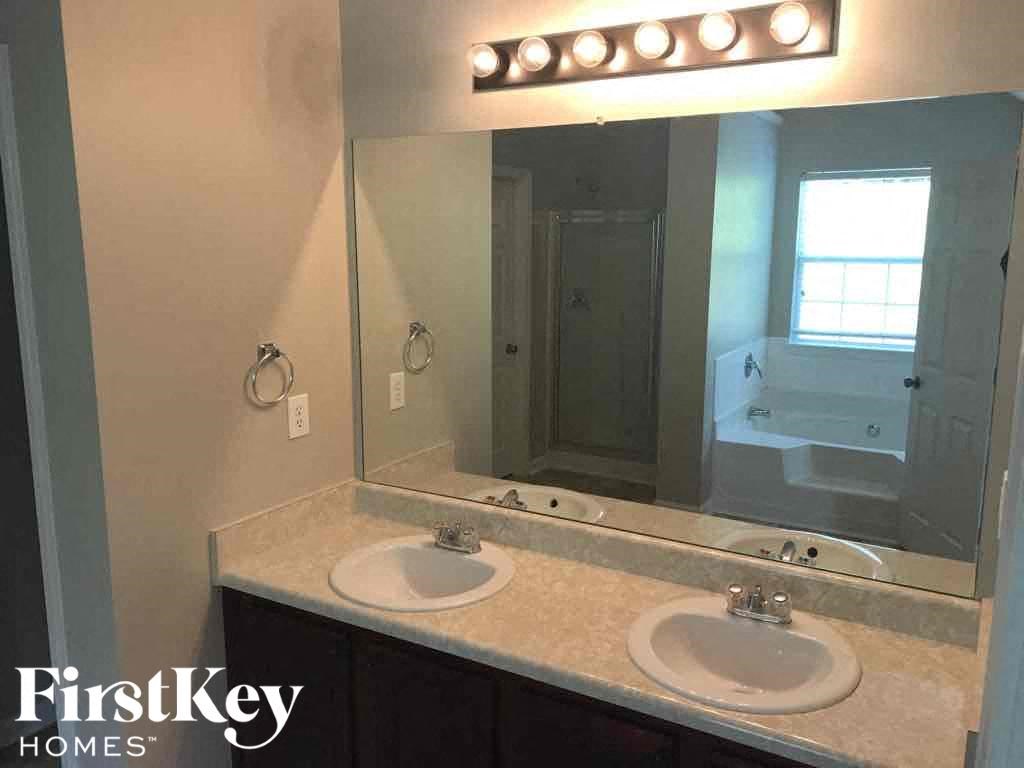 a bathroom with two sinks and a large mirror