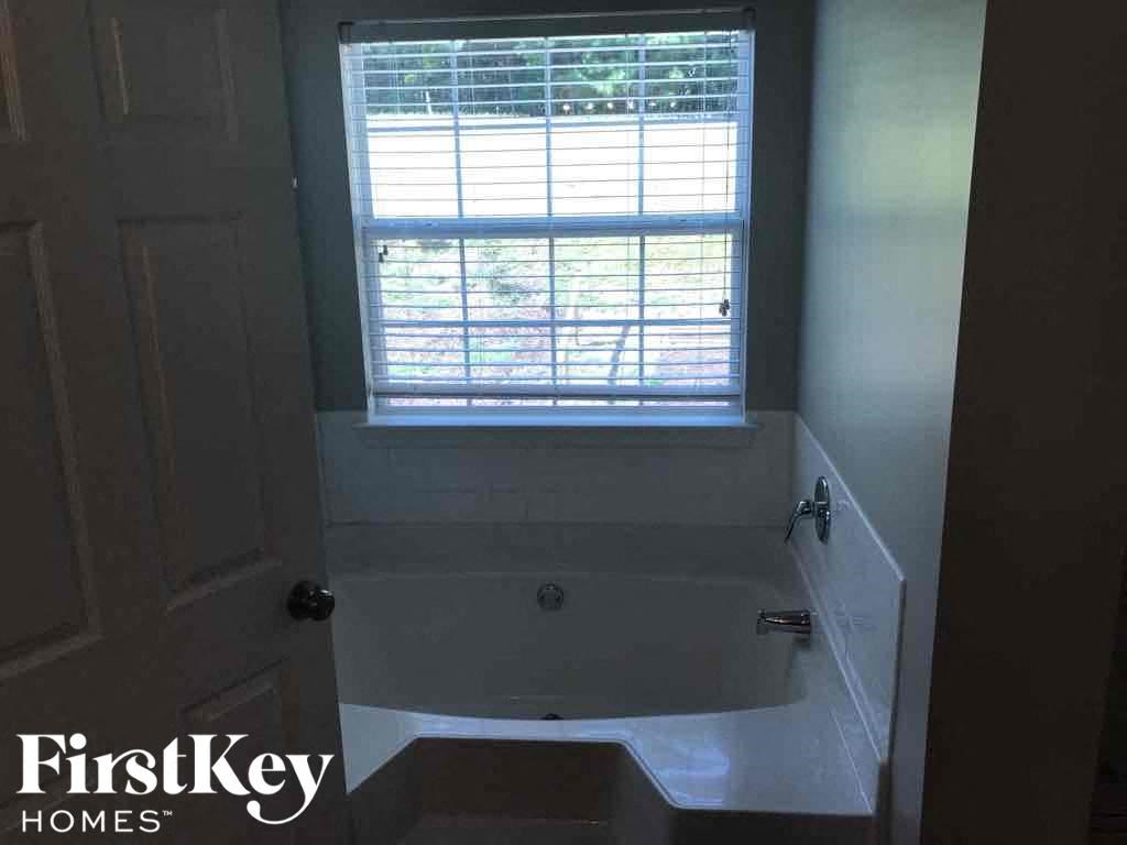 a bathroom with a bath tub and a window