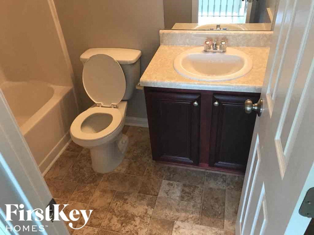 a bathroom with a toilet and a sink and a tub