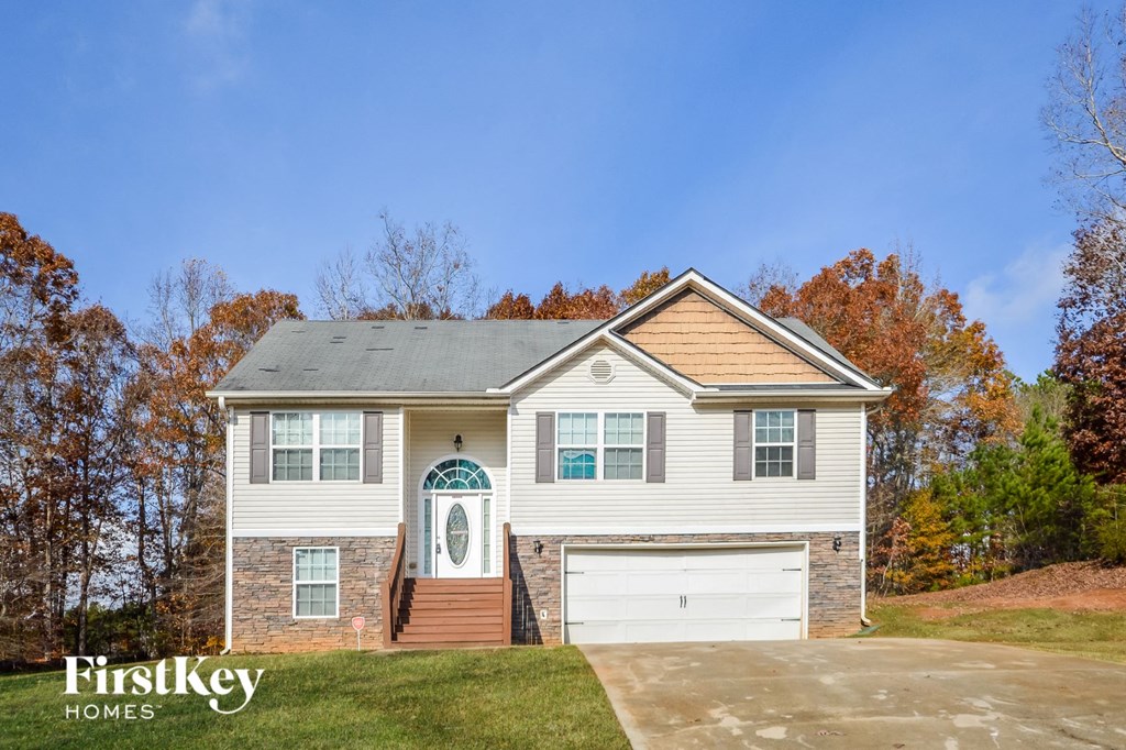 a white house with a white door and a white garage door
