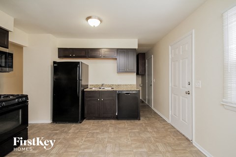 a kitchen with black appliances and a black refrigerator