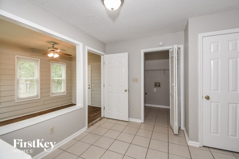 A white door is open to a hallway.