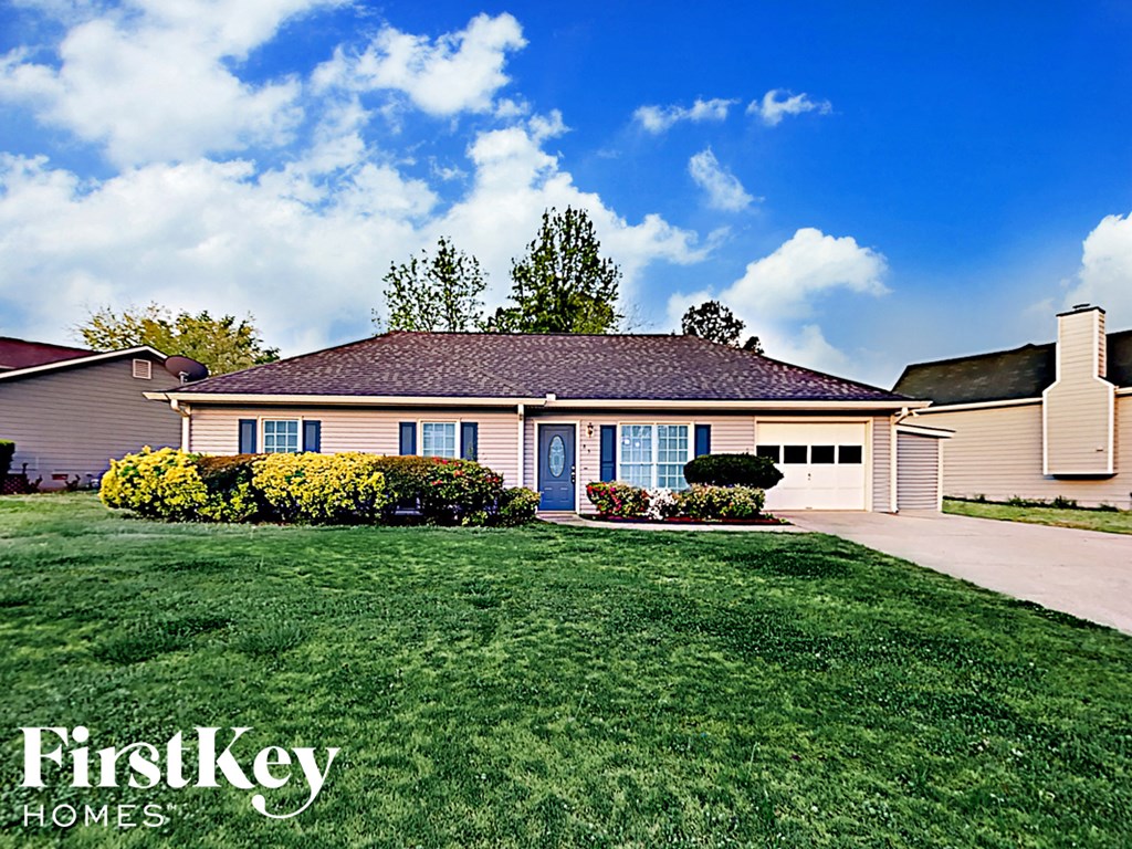 A house with a blue sky and clouds in the background.