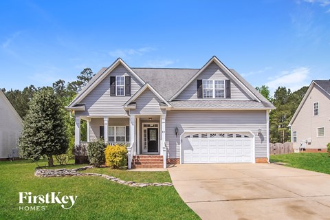 a suburban house with a driveway and a white garage door