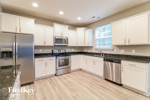 A kitchen with white cabinets and stainless steel appliances.