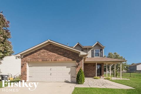 a brick house with a white garage door