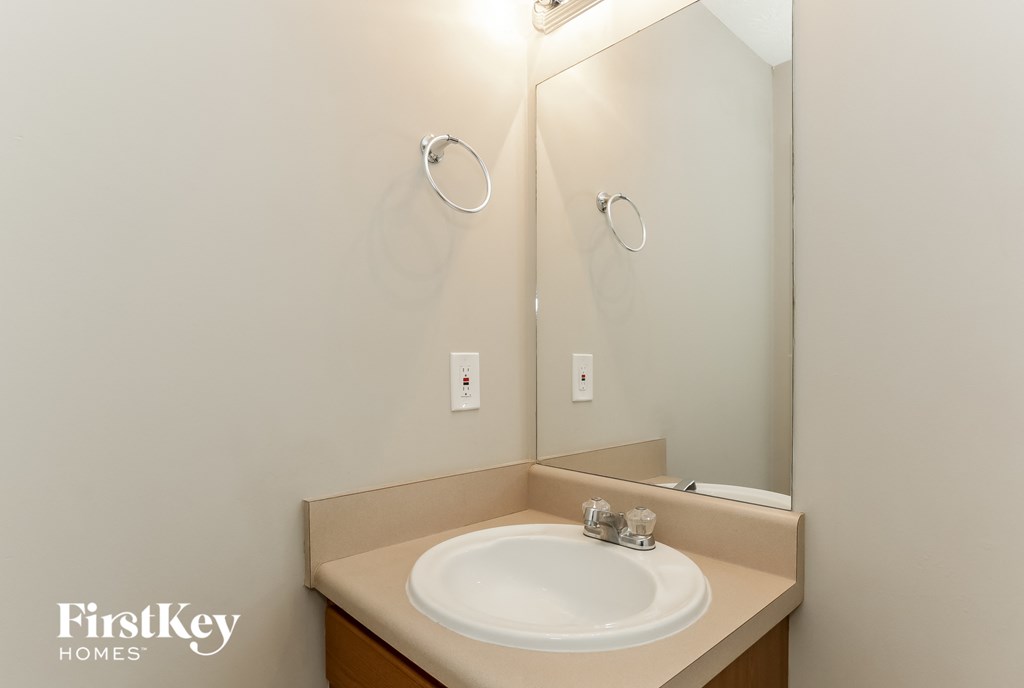 a small bathroom with a sink and a mirror