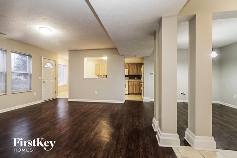 the living room and dining room of an empty house