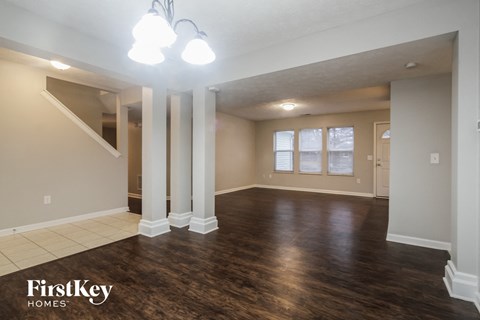 the living room and dining room in an empty house