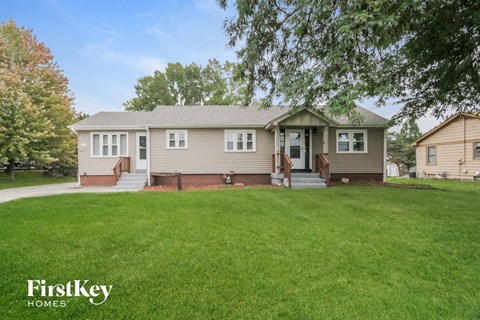 A house with a lawn in front of it.