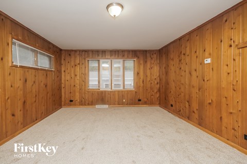 A room with wooden walls and a carpeted floor.