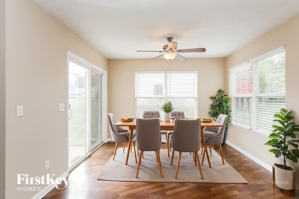 A dining room with a table set for six.