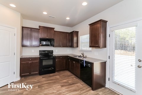 A kitchen with brown cabinets and a stainless steel dishwasher.