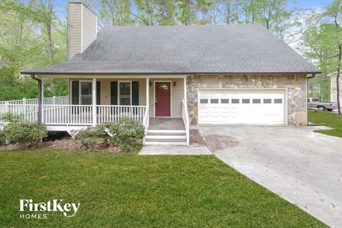 a home with a white porch and a white garage door