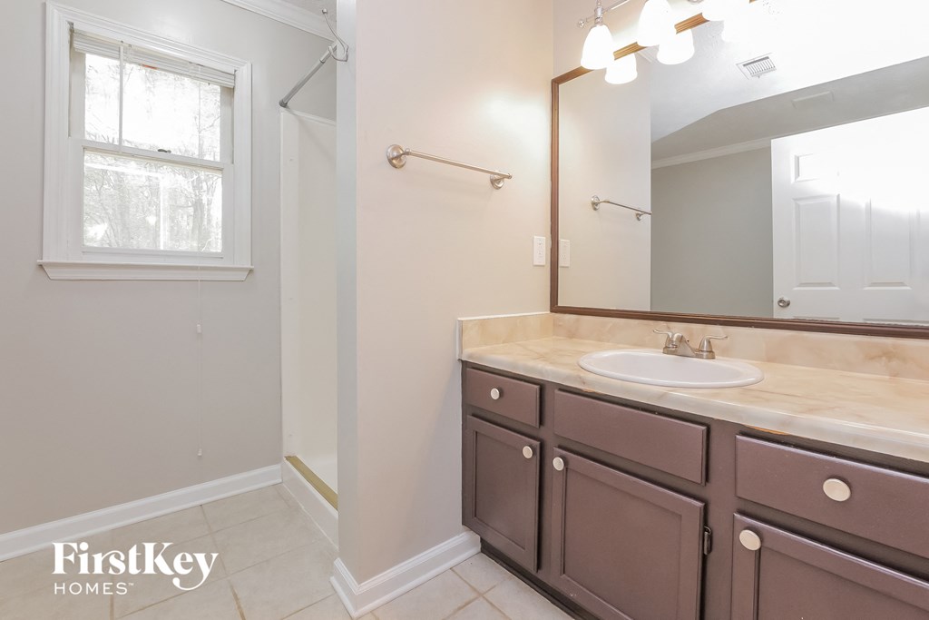 an empty bathroom with a sink and a mirror