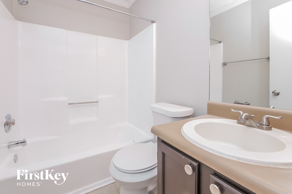 a bathroom with a sink and a toilet and a tub
