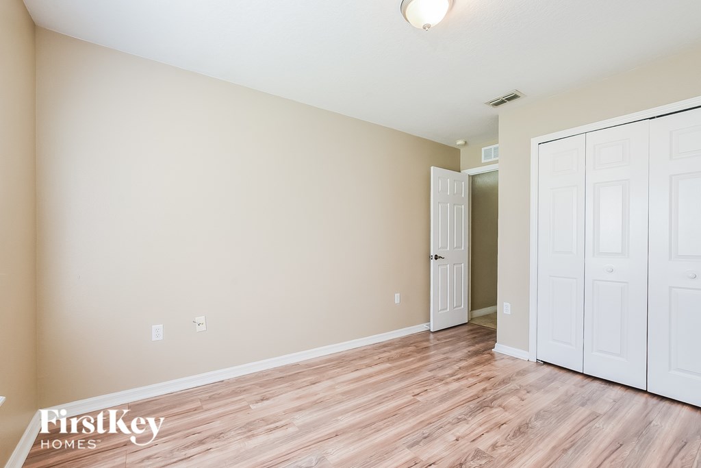A room with a wooden floor and white walls.