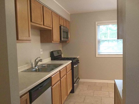 a kitchen with a sink and a stove and a window