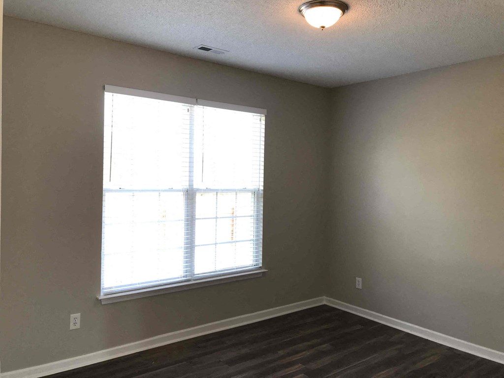 A room with a window and a ceiling light.