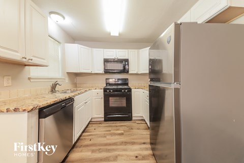 A kitchen with a refrigerator on the right.