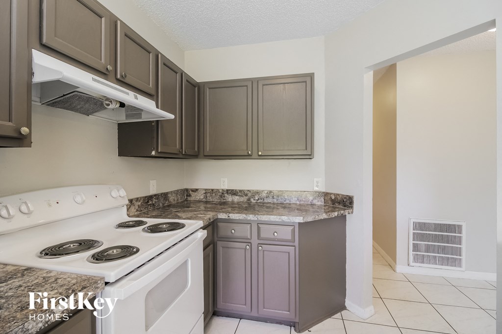 a kitchen with a stove top oven and a counter top