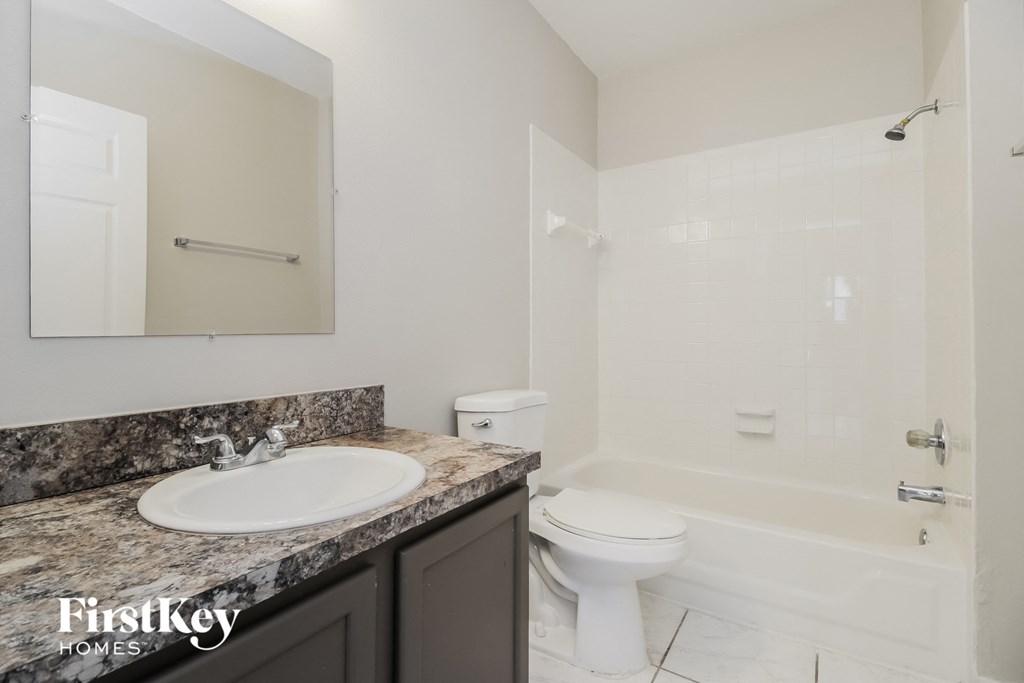 an image of a bathroom with a sink toilet and shower