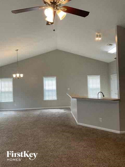 A room with a ceiling fan and a window.