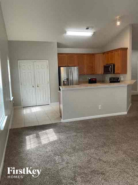 A kitchen with a white door and a white counter top.