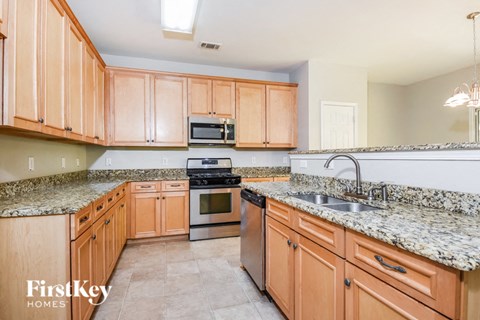 a kitchen with wooden cabinets and granite counter tops