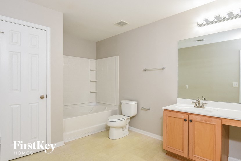 a bathroom with a toilet and a sink and a bath tub