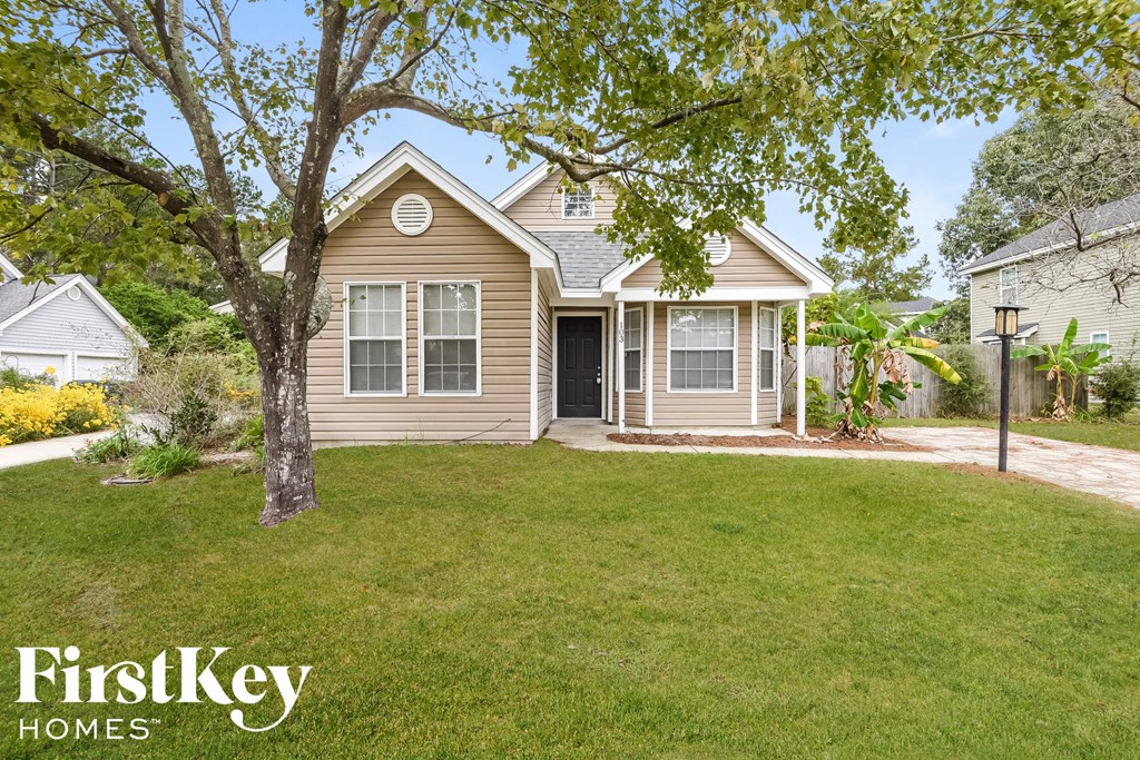 A house with a tree in front of it.