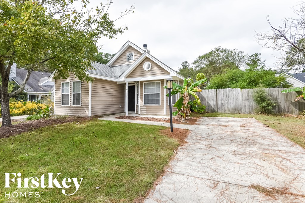 A house with a brown roof and a grey front yard.