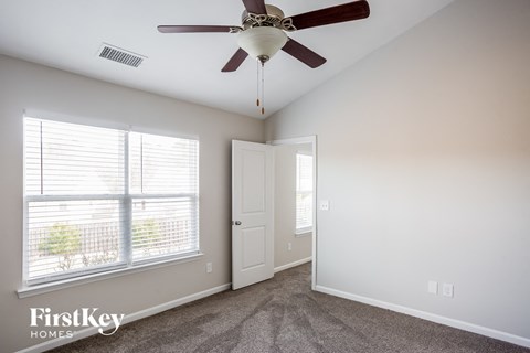 a living room with a ceiling fan and a window