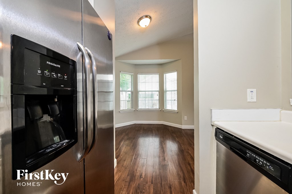 A stainless steel refrigerator with a digital display and water and ice dispenser.
