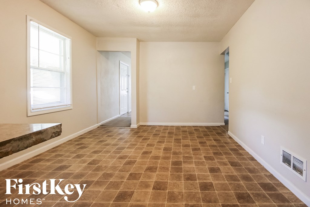 the living room of an empty house with a tiled floor
