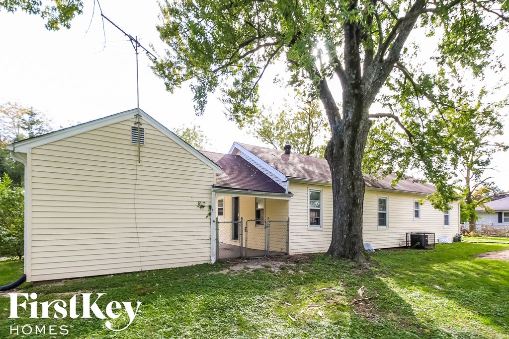 a white house with a large tree in front of it