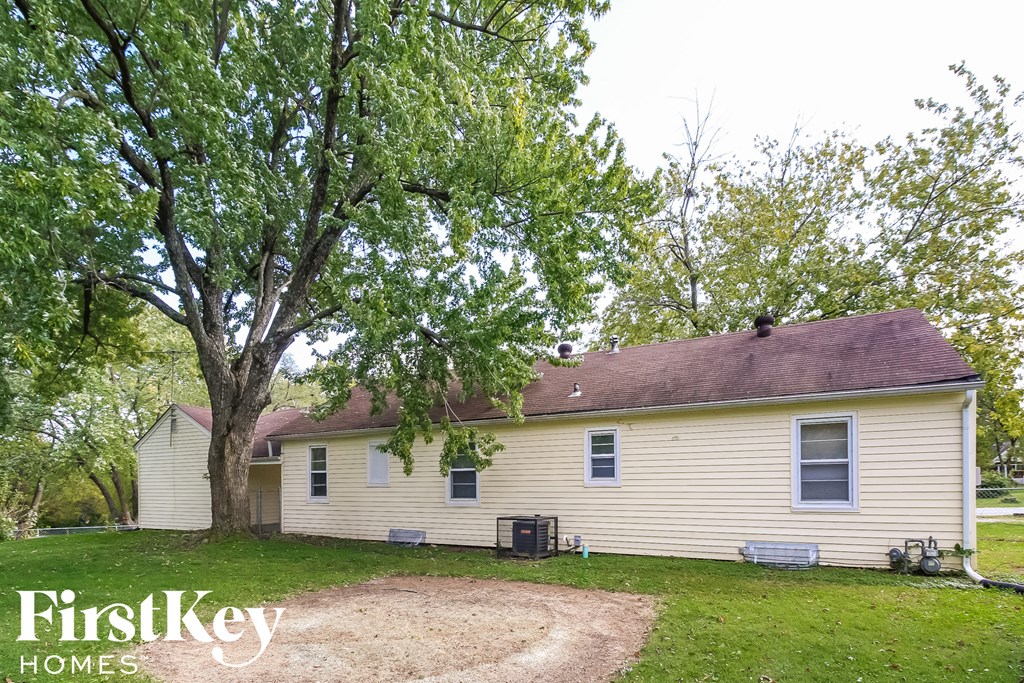 a white house with a tree in front of it