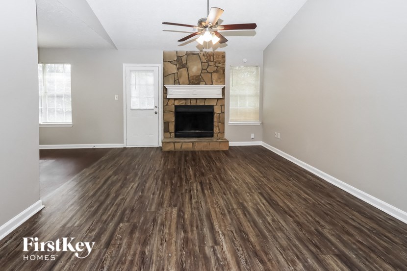 the living room of an empty house with a fireplace