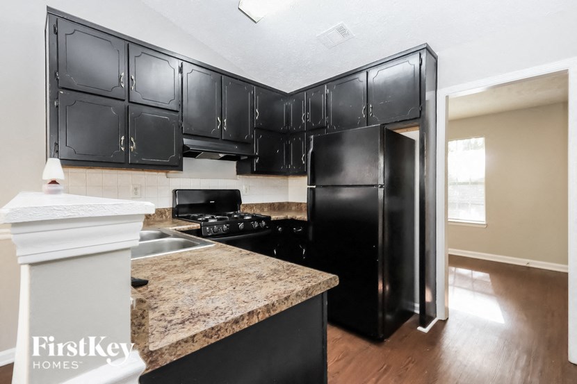a kitchen with black appliances and granite counter tops