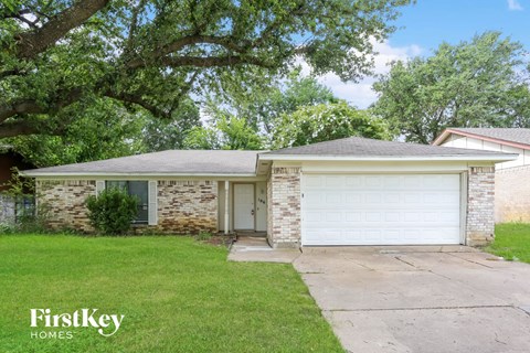 a white brick house with a white garage door