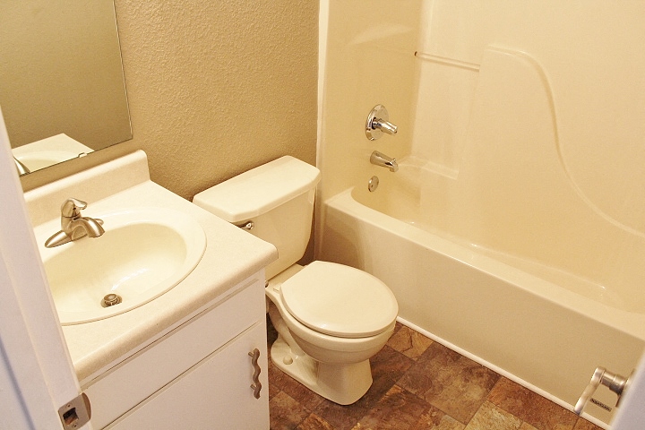a bathroom with a toilet and a sink and a bath tub