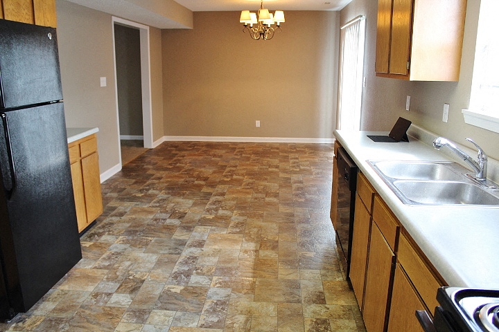 a kitchen with a sink and a refrigerator