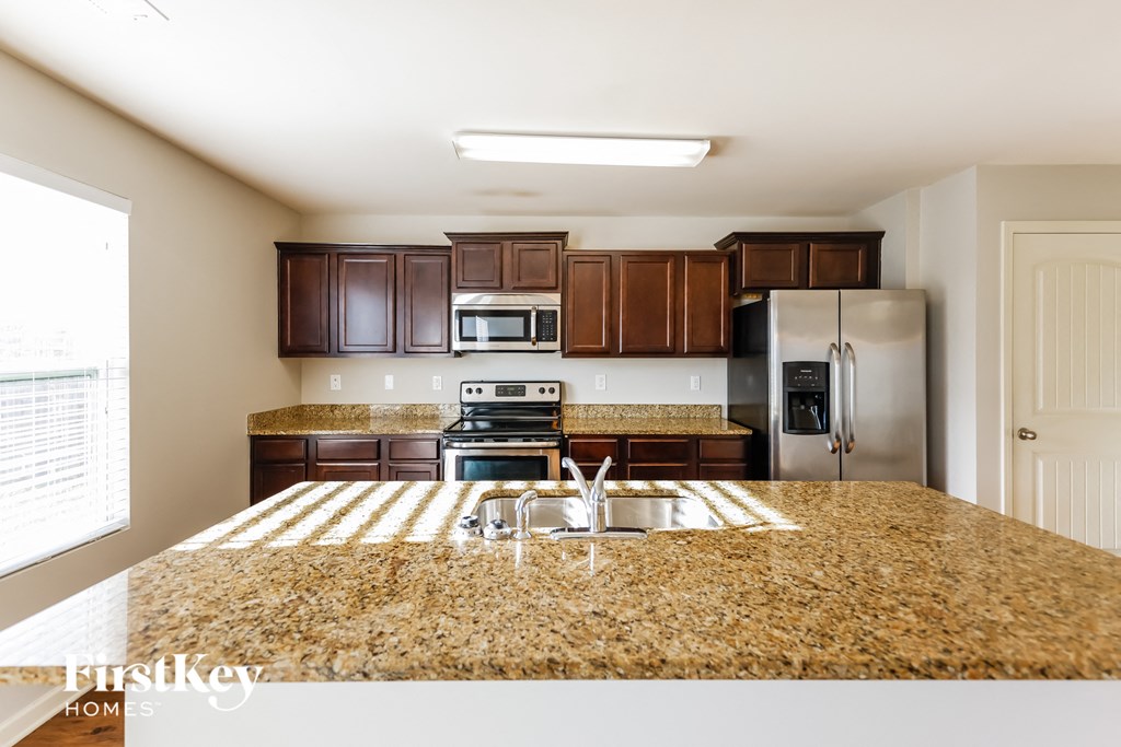 a kitchen with granite counter tops and stainless steel appliances