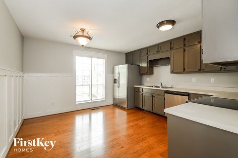 a kitchen with stainless steel appliances and a wood floor