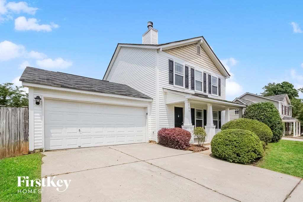 a white house with a garage and a driveway