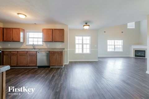 A spacious kitchen with wooden cabinets and a stainless steel refrigerator.